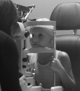 child doing optical exam