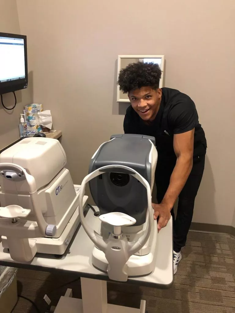 male employee at eye testing machine